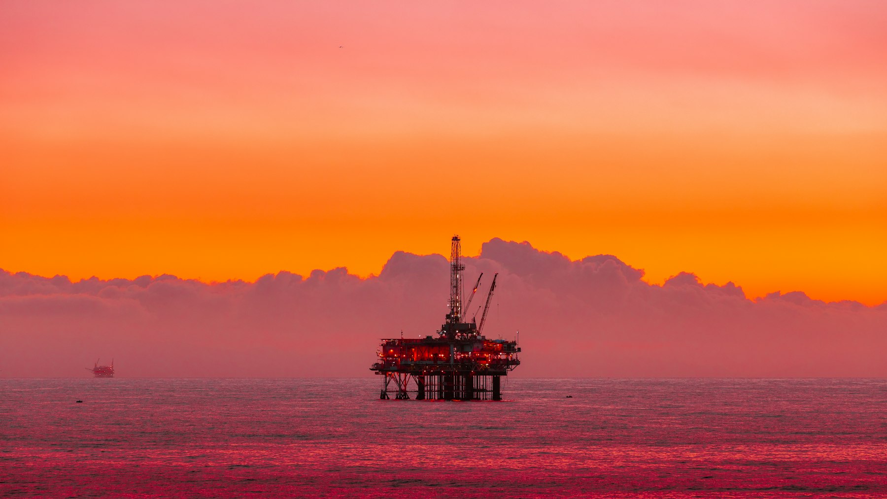 Offshore oil platform at sunset